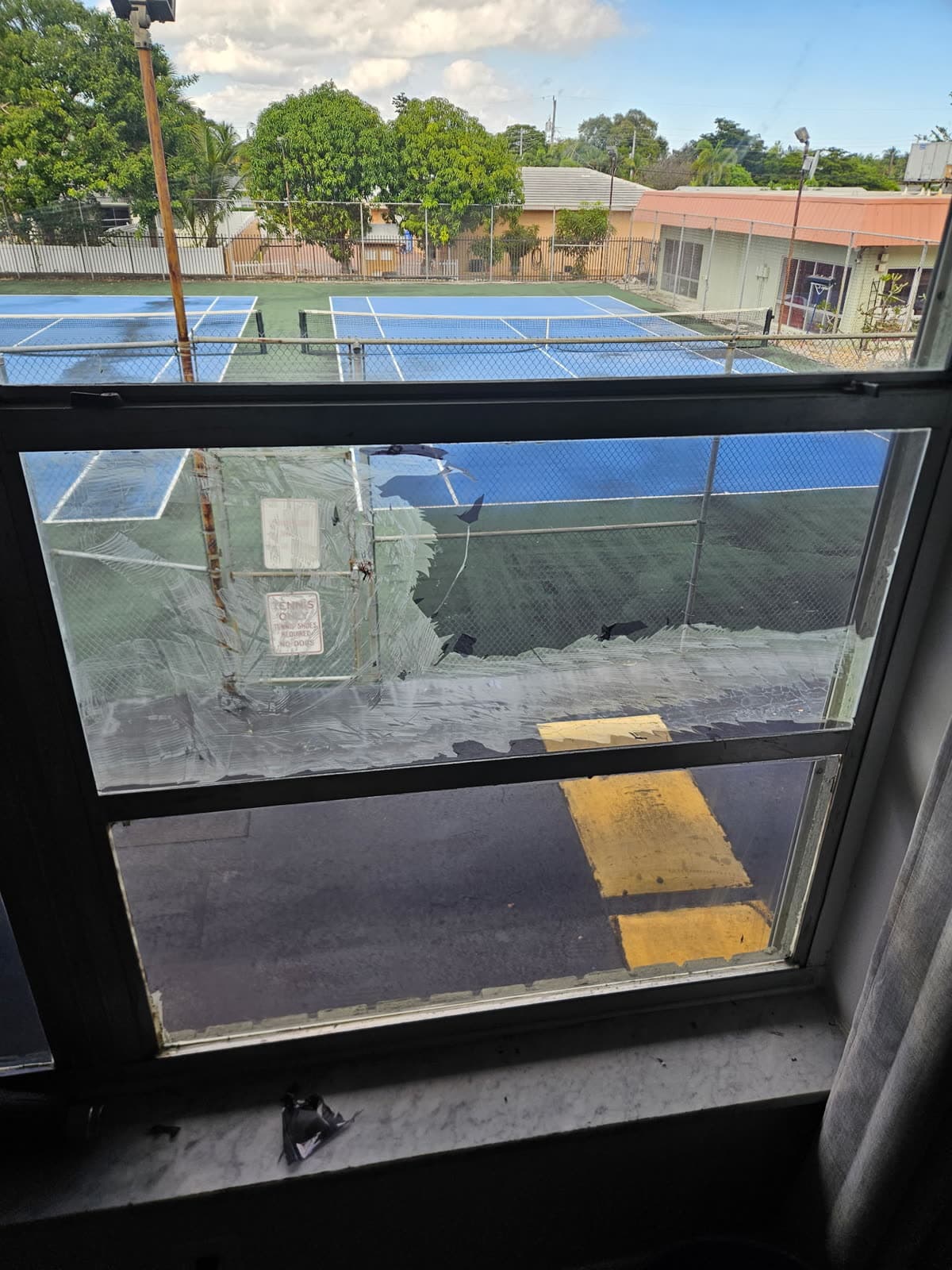Tint adhesive being worked off the glass